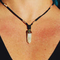 Close-Up of Iridescent Labradorite with White Quartz Pendant Showcasing Colorful Reflections