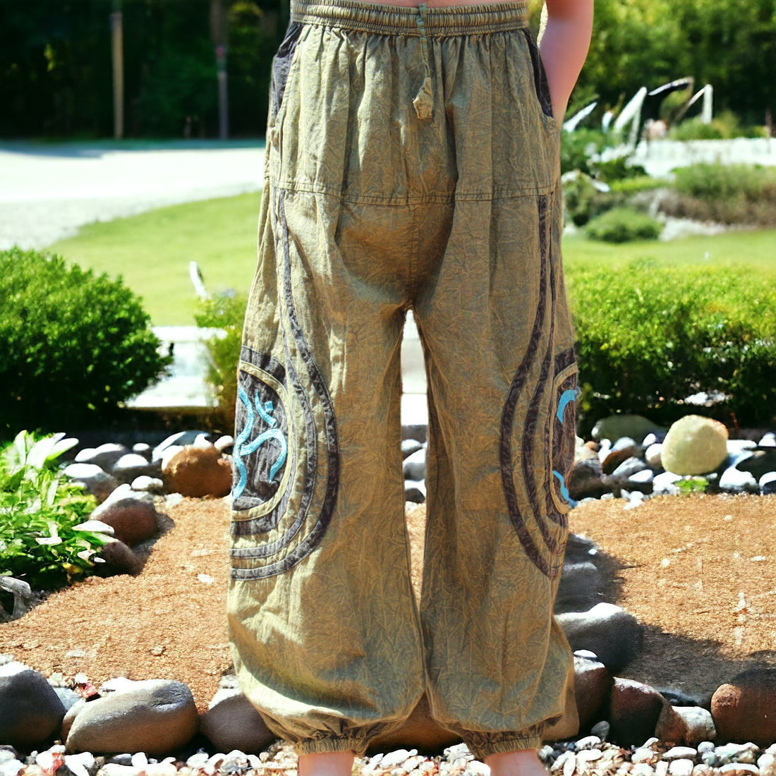 Model showcasing Secret Sense's Earthy Embroidered Harem Pants in a serene garden setting