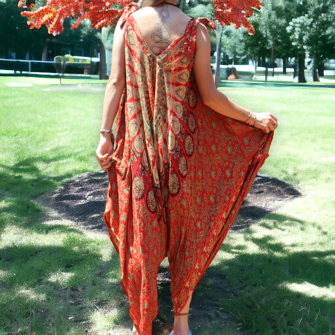 Woman enjoying a vibrant orange Mantra Jumpsuit with Thin Straps by Secret Sense