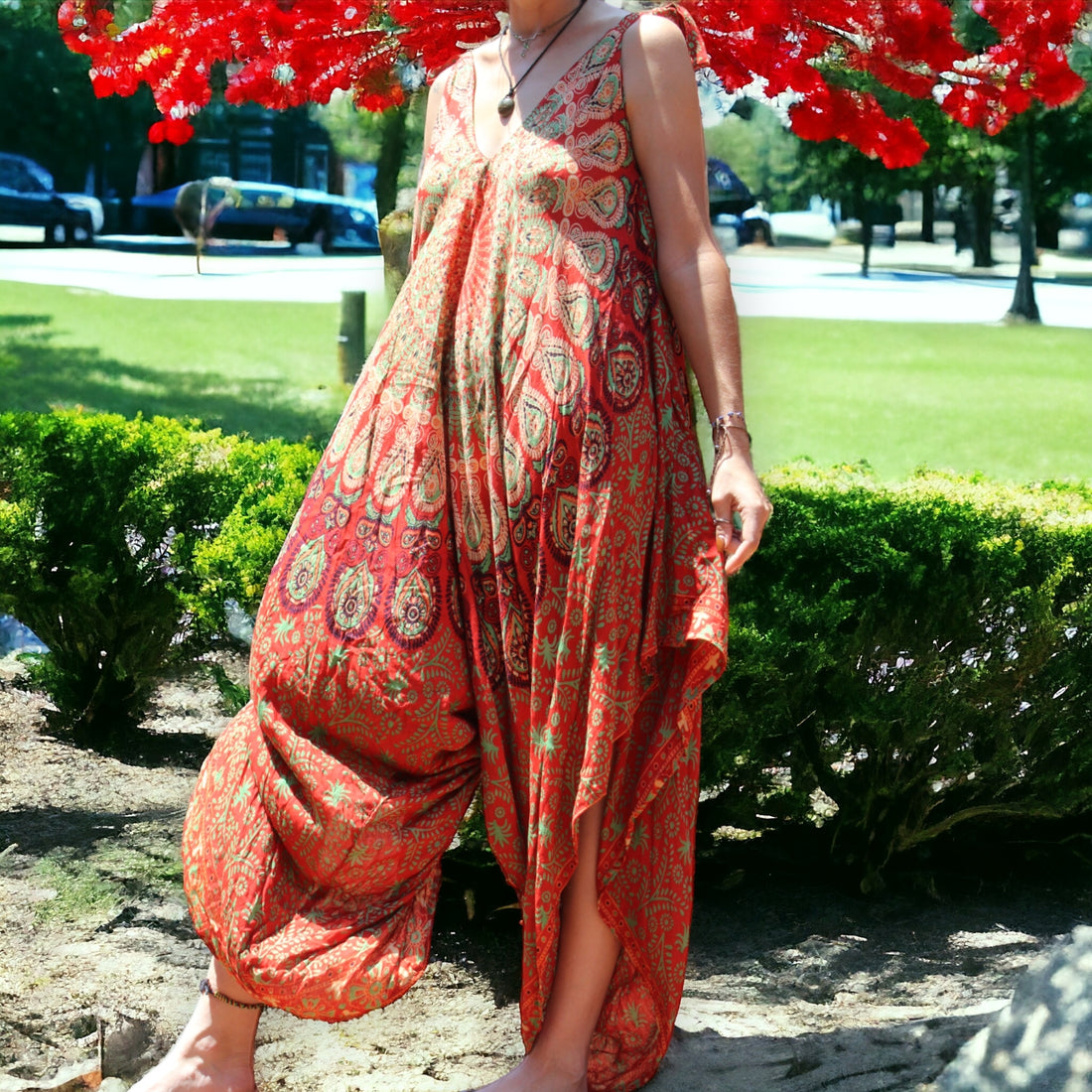 Woman enjoying a vibrant orange Mantra Jumpsuit with Thin Straps by Secret Sense