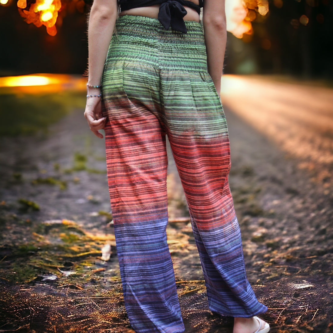 Colorful Secret Sense Forest Striped Harem Pants against a backdrop of dusk